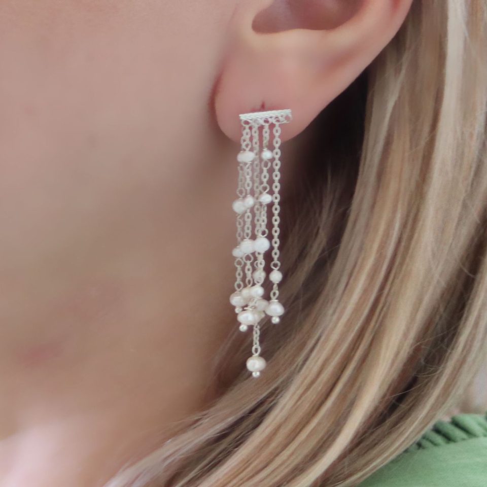 Five-row dangling pearl earrings set in gleaming silver