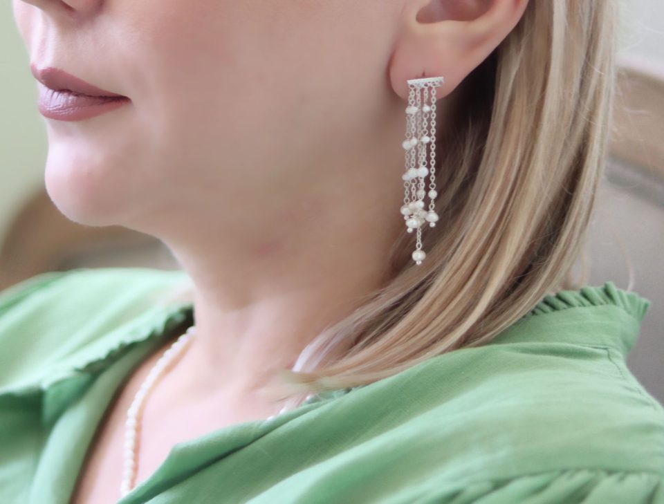 Elegant silver earrings with five cascading rows of lustrous pearls