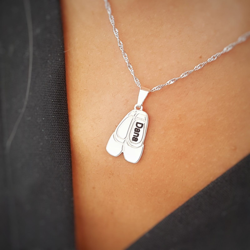 A necklace with ballet shoe pendant