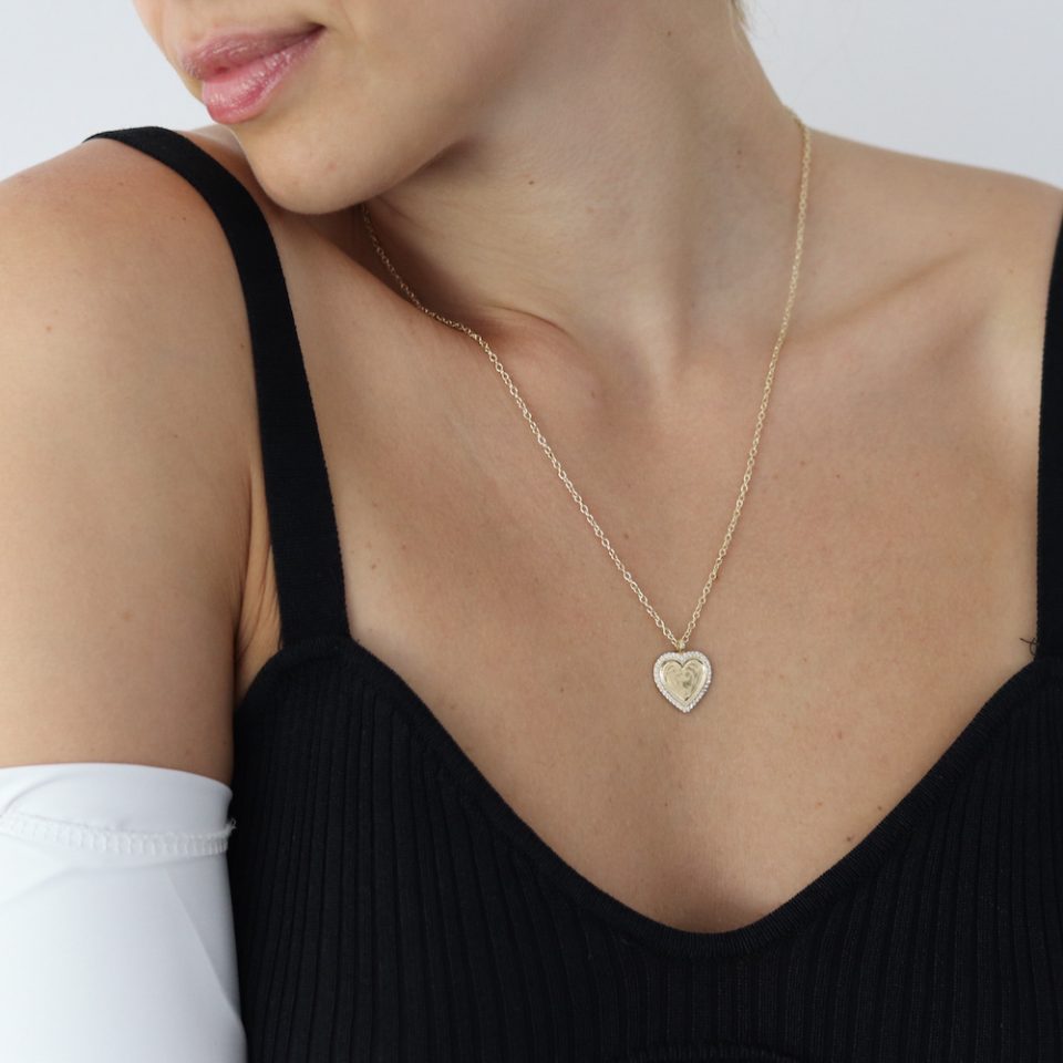 A necklace with inlaid heart pendant in gold plated