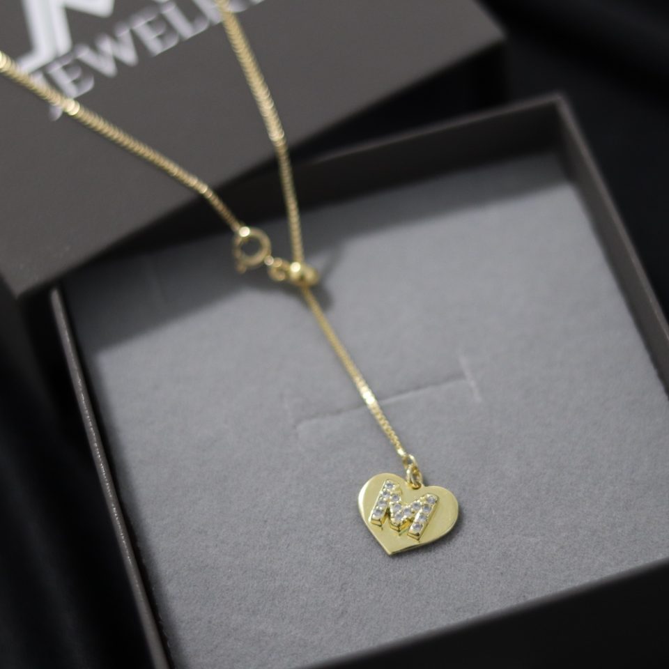 A necklace with inlaid letter heart pendant