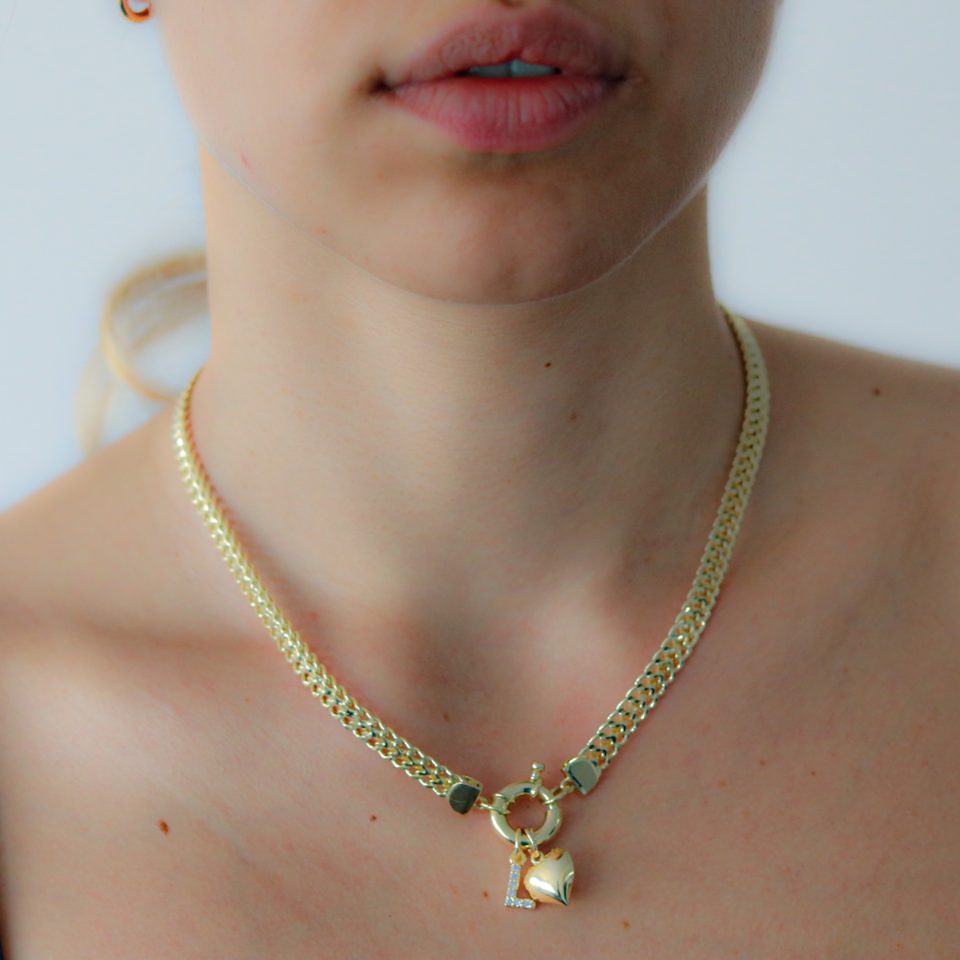 A necklace with Puffy heart pendant and letter in gold