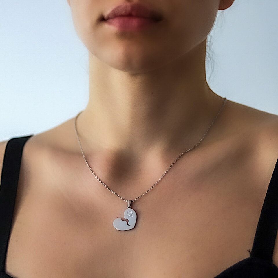 A woman with a broken heart necklace and pendant and the shield of Israel