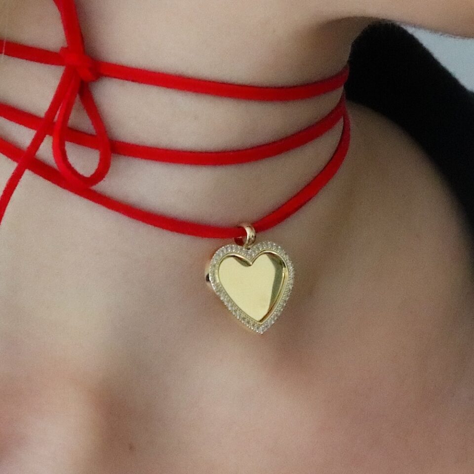 Red cord with gold heart pendant set with stones